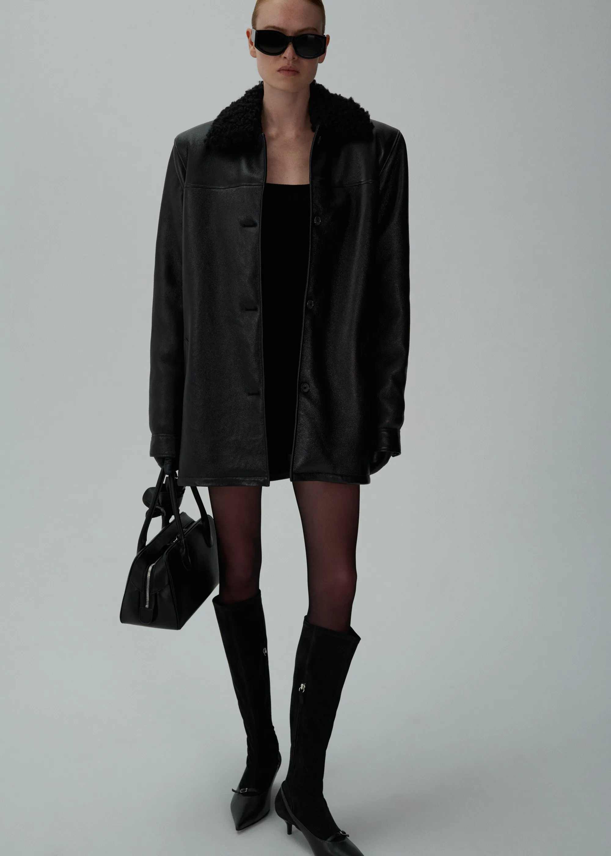 Oversized shearling-trim leather button-up jacket in black